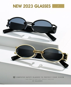 Detailed view of retro oval metal sunglasses featuring black and gold frames on white steps