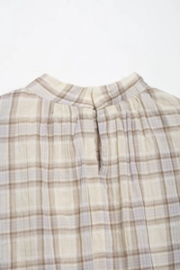 Close-up of the back neckline on a plaid crop top featuring a textured seersucker fabric