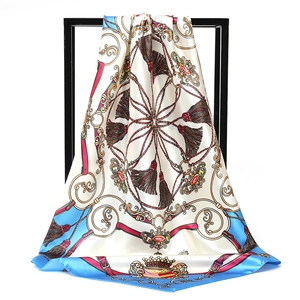 Detailed view of satin square scarf featuring vintage red belt and golden chain prints
