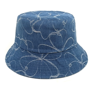Close-up of white floral embroidery on premium deep blue washed denim bucket hat