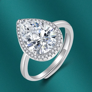 Macro detail of silver pear-shaped halo ring with teardrop gemstone and open band design