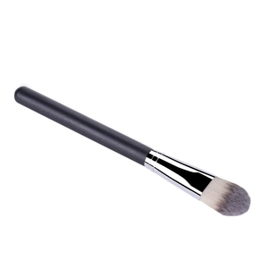 Macro detail of dense synthetic bristles and silver ferrule on foundation brush