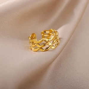 Detail of a vintage gold-plated Cuban link ring on champagne silk background