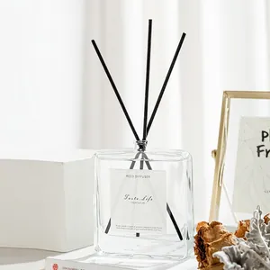 Minimalist square glass reed diffuser with black fiber sticks in a home setting