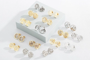 Macro detail of various stainless steel stud earrings in gold and silver cutout designs