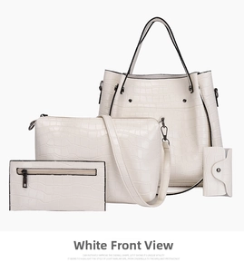 Close-up of four-piece white crocodile pattern bag set with polished dark hardware