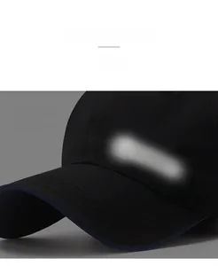 Detail of reflective logo on black quick-dry baseball cap for night safety visibility