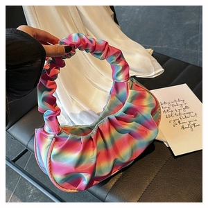 Close-up of vibrant rainbow gradient pleated shoulder bag with soft satin texture handles