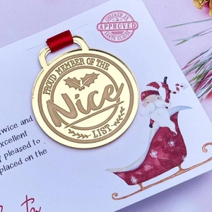 Gold Christmas medal Proud Member of the Nice List with red ribbon and holiday card