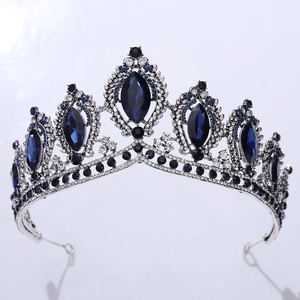 Macro detail of silver bridal tiara with faceted dark blue crystals and rhinestones