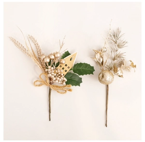 Close-up of golden berries and miniature wooden house ornaments on Christmas picks