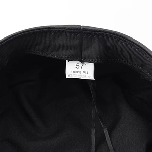 Detail shot of the black punk military hat inner lining with size 57 and 100% PU label