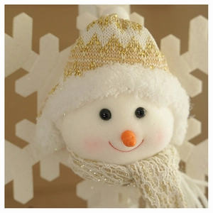 Macro detail of plush snowman hanging ornament with knit hat and golden scarf