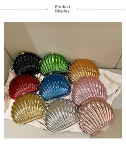 Detailed view of luxury shell-shaped evening clutches in various metallic colors with gold clasp