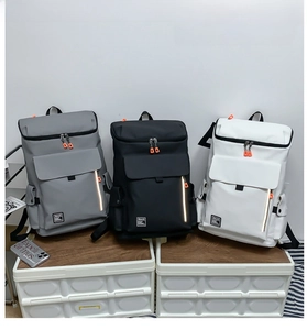 Detailed view of urban backpacks in gray, black, and white colors with safety reflective strips