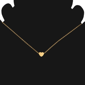 Detail of a gold heart pendant necklace on a black silhouette mannequin