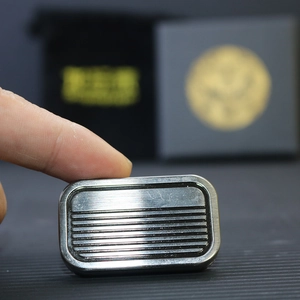 Macro shot of silver metal slider EDC toy with anti-slip grooves and brushed texture