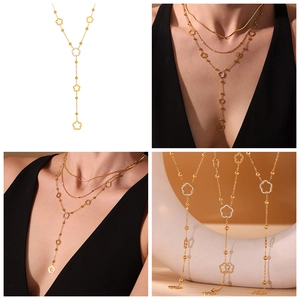 Detail view of gold flower tassel necklace featuring sparkling zircon pave in 5A quality