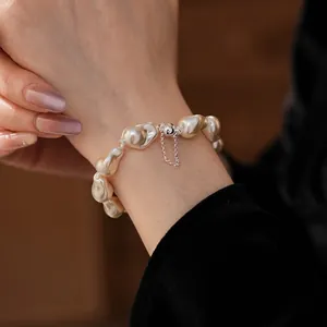 Baroque irregular pearl bracelet with magnetic silver clasp worn on a female wrist