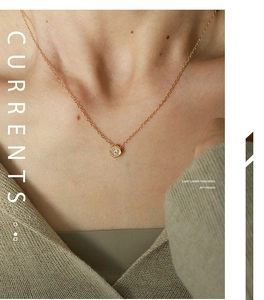 Close-up of gold geometric hexagonal pendant with sparkling cubic zirconia on necklace