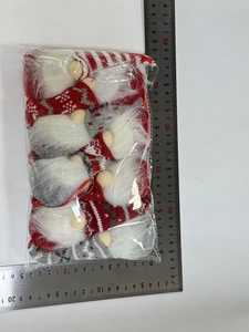 Size measurement of four knit Christmas gnomes ornaments in clear plastic packaging