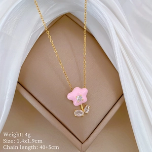 Detail of pink flower pendant necklace with crystals on beige box with silk fabric