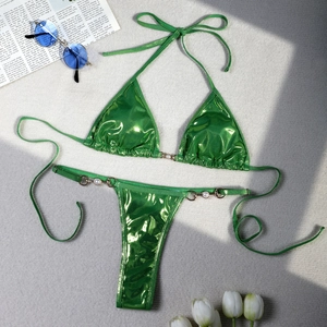 Detail of lime green metallic bikini bottoms featuring gold rings and pearl accents