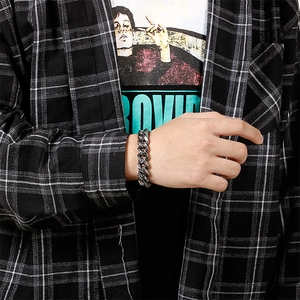 Close-up of retro gothic engraved pattern on a chunky stainless steel link bracelet