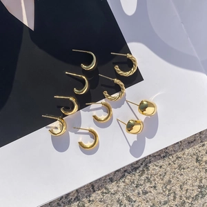 Detailed top view of 14K gold plated stainless steel C-shaped and textured earrings