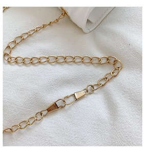 Close-up of golden metal chain strap with secure clasp for children heart bag