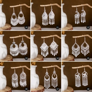 Set of 9 vintage silver bohemian earrings with peacock bell and leaf tassel designs