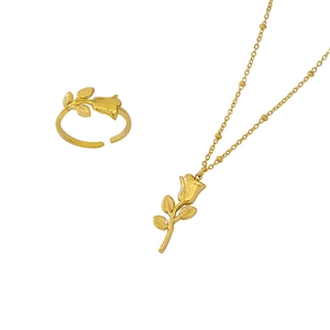 Golden rose jewelry set featuring a realistic flower ring and necklace on white background