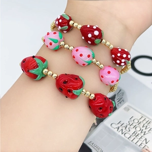 Three-piece strawberry beaded bracelet set with red glass fruits and golden metal beads
