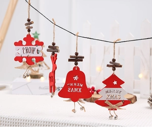Detail of wooden Christmas ornaments featuring snowflakes and reindeer on a tree