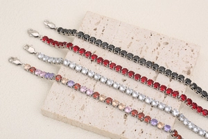 Detail of tennis bracelets with multicolored crystals and 18K gold plated lobster clasp