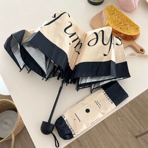 French vintage style beige and black folding sun umbrella with protective storage bag