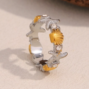 Detailed side view of 18K gold starfish and seashell ring with sparkling crystals