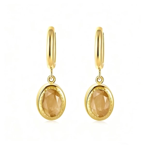 Elegant gold earrings with oval champagne zircon stones and round clasps on white background