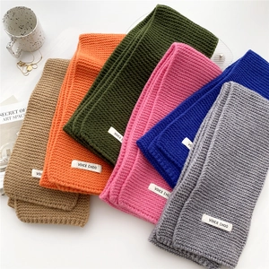 Thick knitted scarves in various solid colors like khaki and green on a white background