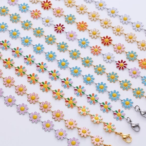 Detail view of colorful enamel daisy charms on gold and silver plated chains