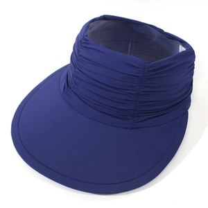 Detail view of the wide brim and elastic pleated crown on a navy blue sun protection hat