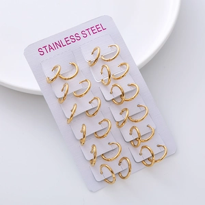 Set of 12 pairs of minimalist golden stainless steel hoop earrings on a display card