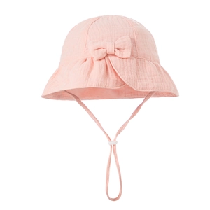 Detail of pink cotton baby sun hat featuring textured fabric and a decorative bow