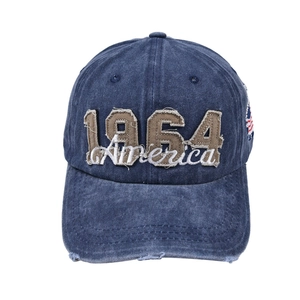Detail of 1964 America embroidery and distressed frayed edges on a vintage denim baseball cap