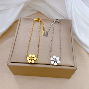 Elegant stainless steel flower bracelets in gold and silver finish on silk fabric