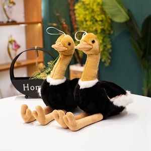 Realistic ostrich plush toy with black fur and long neck on a cozy home background