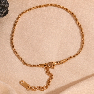 Detail of 18K gold plated 2mm twist chain anklet with lobster clasp on silk fabric