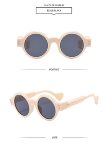 Close-up of retro round beige frames with dark lenses and silver stud details