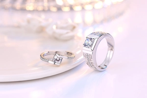 Macro detail of adjustable silver couple rings with geometric patterns and sparkling zircons