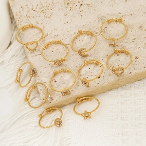 Luxurious gold ring set with zircon heart and moon charms on textured open bands